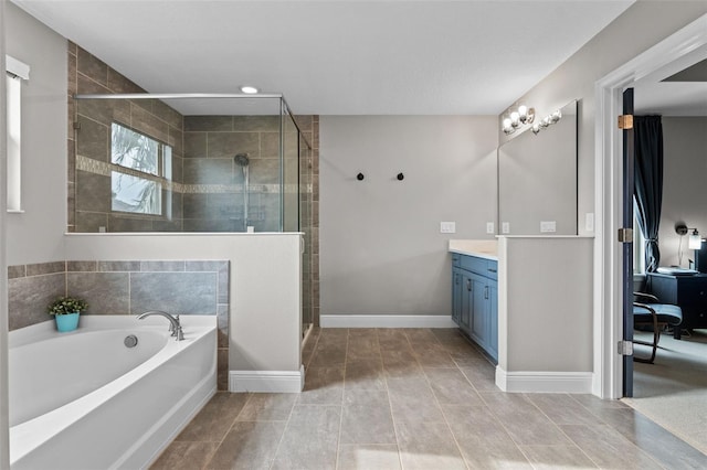 3865 W Stillwood Ln, Lake Mary, FL 32746 - bathroom featuring vanity, a garden tub, a shower stall, baseboards, and recessed lighting