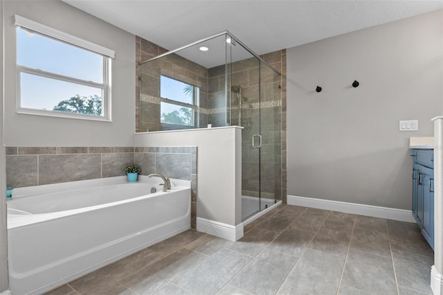 3865 W Stillwood Ln, Lake Mary, FL 32746 - full bathroom with vanity, a garden tub, a stall shower, baseboards, and tile patterned floors