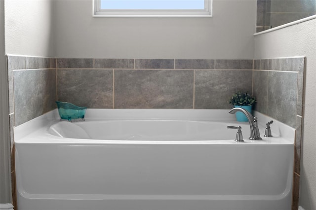 3865 W Stillwood Ln, Lake Mary, FL 32746 - bathroom with a bath, plenty of natural light, and a textured wall