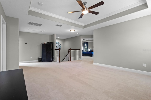 3865 W Stillwood Ln, Lake Mary, FL 32746 - unfurnished room featuring a raised ceiling, crown molding, light colored carpet, a ceiling fan, and baseboards