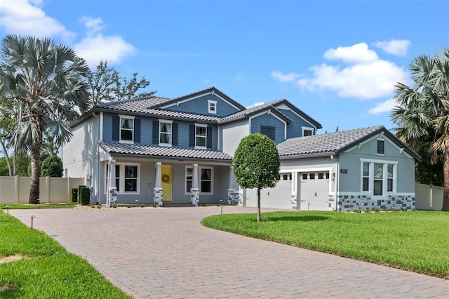 3865 W Stillwood Ln, Lake Mary, FL 32746 - view of front of home featuring a tile roof, a porch, an attached garage, driveway, and stucco siding