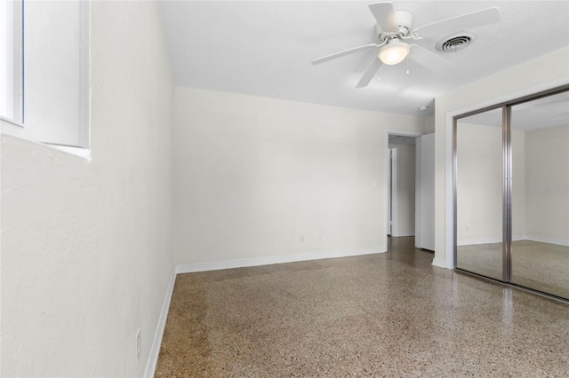 1340 Continental Dr, Daytona Beach, FL 32117 - unfurnished bedroom with speckled floor, a closet, baseboards, and a ceiling fan