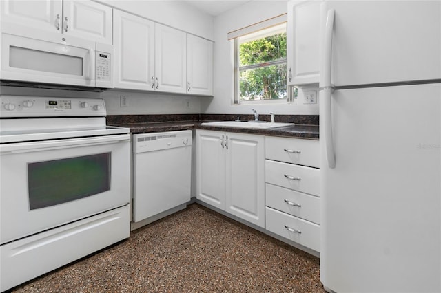 1340 Continental Dr, Daytona Beach, FL 32117 - kitchen featuring white appliances, a sink, white cabinetry, and dark countertops