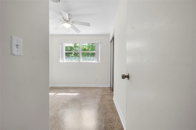 1340 Continental Dr, Daytona Beach, FL 32117 - unfurnished room with speckled floor, ceiling fan, and baseboards