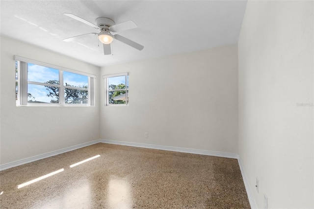 1340 Continental Dr, Daytona Beach, FL 32117 - unfurnished room featuring ceiling fan, speckle patterned floor, and baseboards