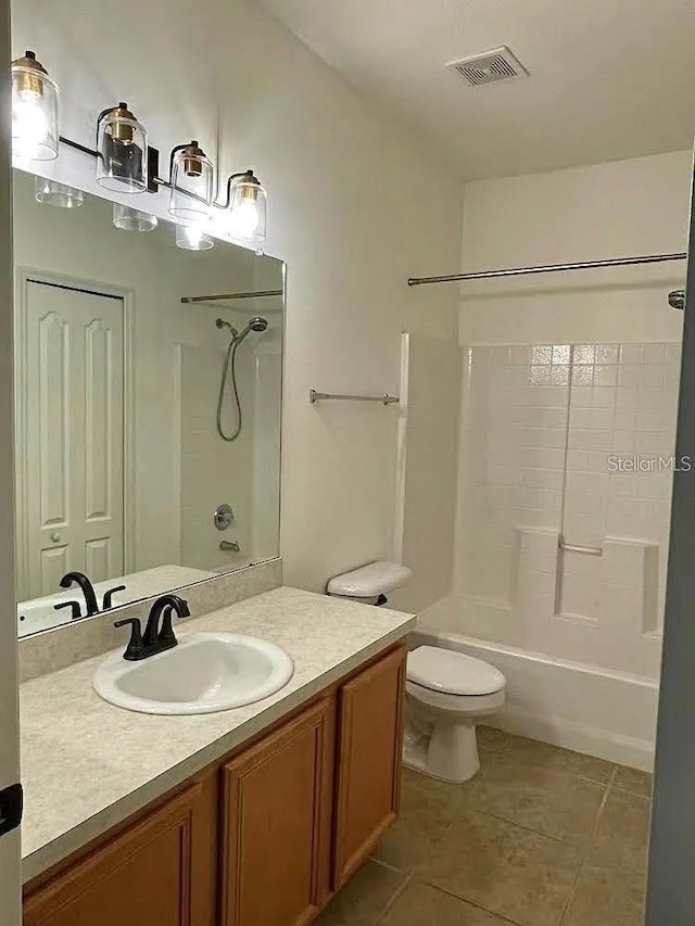 bathroom featuring tile patterned floors, shower / tub combination, toilet, and vanity