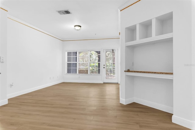 3561 Conroy Rd Unit 216, Orlando, FL 32839 - unfurnished living room featuring baseboards and wood finished floors