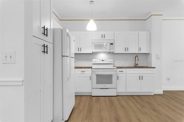 3561 Conroy Rd Unit 216, Orlando, FL 32839 - kitchen with white appliances, decorative backsplash, white cabinets, and ornamental molding