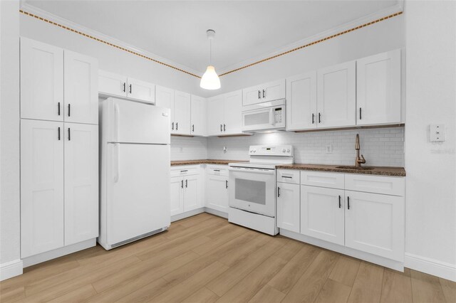 3561 Conroy Rd Unit 216, Orlando, FL 32839 - kitchen featuring white appliances, a sink, backsplash, light wood-style flooring, and dark countertops