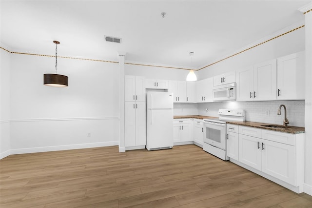 3561 Conroy Rd Unit 216, Orlando, FL 32839 - kitchen featuring white appliances, a sink, white cabinets, light wood-style floors, and backsplash