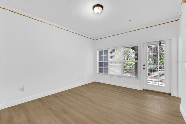 3561 Conroy Rd Unit 216, Orlando, FL 32839 - unfurnished room featuring baseboards, wood finished floors, and ornamental molding