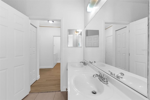 3561 Conroy Rd Unit 216, Orlando, FL 32839 - full bath featuring baseboards, tile patterned flooring, and double vanity