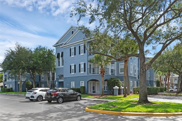 3561 Conroy Rd Unit 216, Orlando, FL 32839 - view of building exterior with uncovered parking