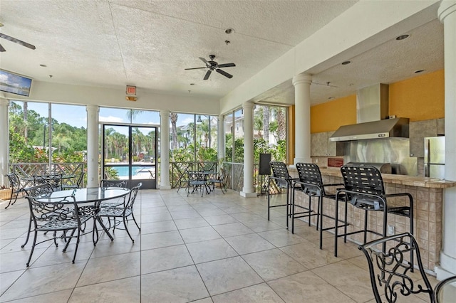 3561 Conroy Rd Unit 216, Orlando, FL 32839 - sunroom with ornate columns, a textured ceiling, and tile patterned floors