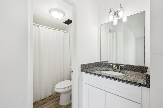 935 S Atlantic Ave Unit 302, Daytona Beach, FL 32118 - full bath with toilet, wood finished floors, and vanity