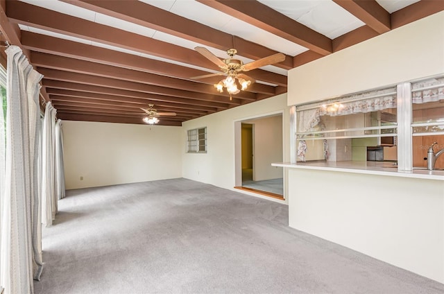 1322 Royal Birkdale Cir, Rockledge, FL 32955 - unfurnished living room featuring beamed ceiling, a ceiling fan, carpet flooring, and a sink