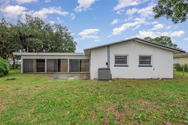 1322 Royal Birkdale Cir, Rockledge, FL 32955 - rear view of house featuring a sunroom, cooling unit, and stucco siding