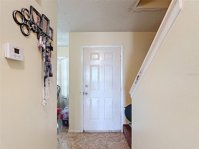 1806 Foxhall Cir Unit 1806, Kissimmee, FL 34741 - doorway with a textured ceiling and light tile patterned floors