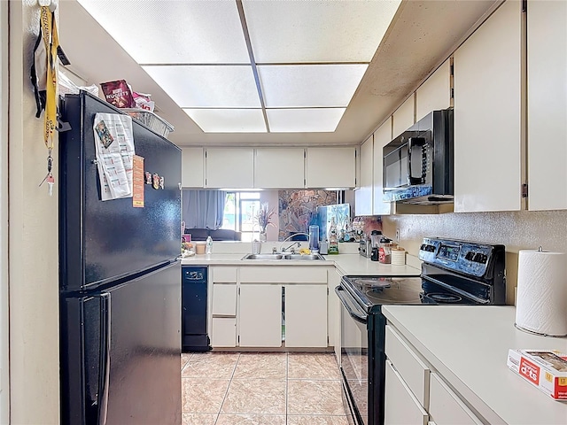 1806 Foxhall Cir Unit 1806, Kissimmee, FL 34741 - kitchen featuring black appliances, light countertops, a sink, light tile patterned floors, and white cabinets