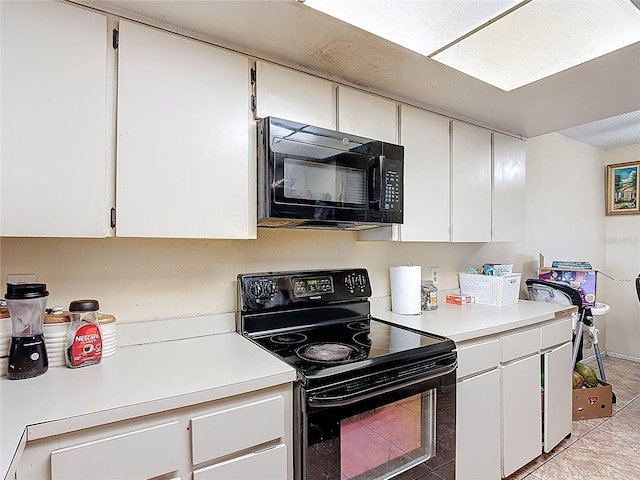 1806 Foxhall Cir Unit 1806, Kissimmee, FL 34741 - kitchen with black appliances, light countertops, light tile patterned flooring, and white cabinetry