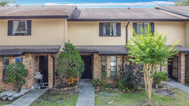 1806 Foxhall Cir Unit 1806, Kissimmee, FL 34741 - townhome / multi-family property featuring roof with shingles and brick siding