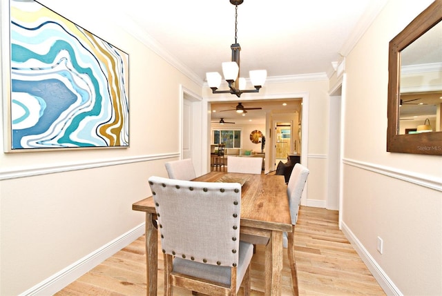 507 N Peninsula Ave, New Smyrna Beach, FL 32169 - dining area featuring a chandelier, light wood-type flooring, ornamental molding, ceiling fan, and baseboards