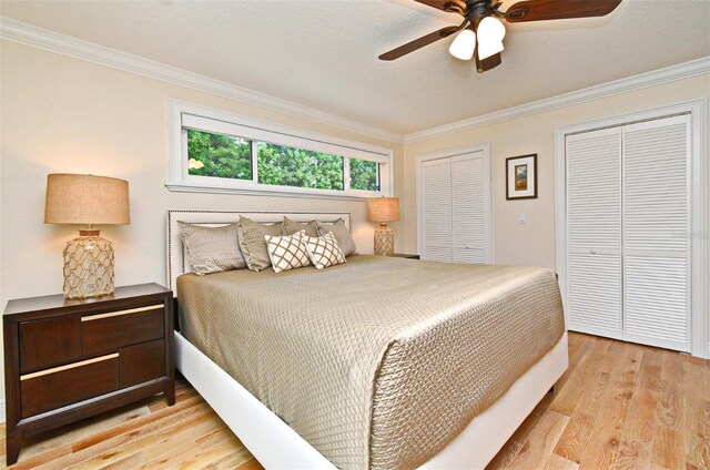 507 N Peninsula Ave, New Smyrna Beach, FL 32169 - bedroom with ornamental molding, light wood finished floors, multiple closets, and ceiling fan