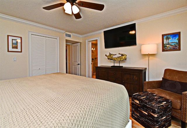507 N Peninsula Ave, New Smyrna Beach, FL 32169 - bedroom with ornamental molding, a textured ceiling, a closet, and a ceiling fan