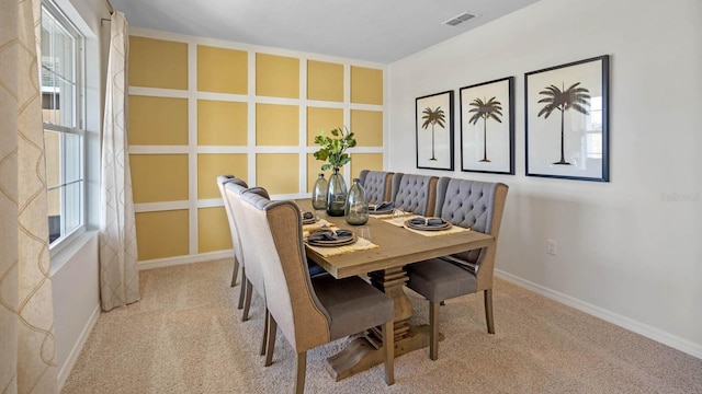 dining space featuring carpet floors and baseboards