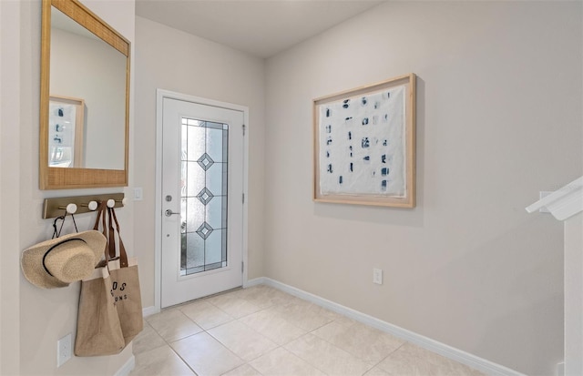 tiled foyer featuring baseboards