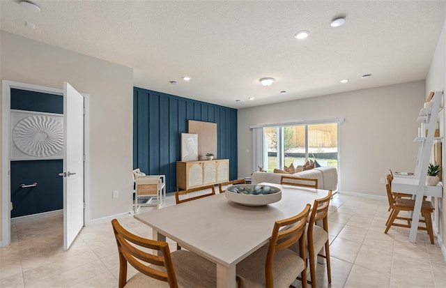 dining area with a textured ceiling, light tile patterned floors, recessed lighting, and baseboards