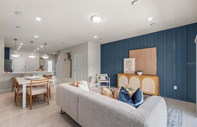 living room featuring recessed lighting, baseboards, and light tile patterned floors