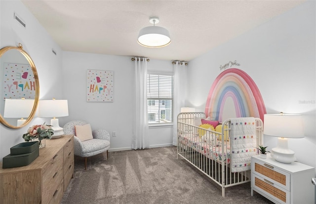 carpeted bedroom featuring baseboards and a nursery area