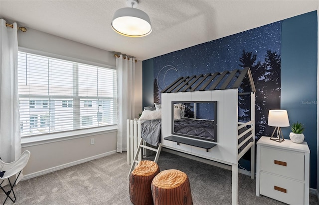 carpeted bedroom featuring baseboards and a textured ceiling