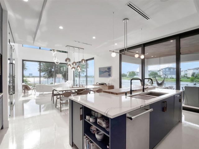 8157 Elion St, Orlando, FL 32827 - kitchen featuring a sink, stainless steel dishwasher, an island with sink, light stone countertops, and pendant lighting