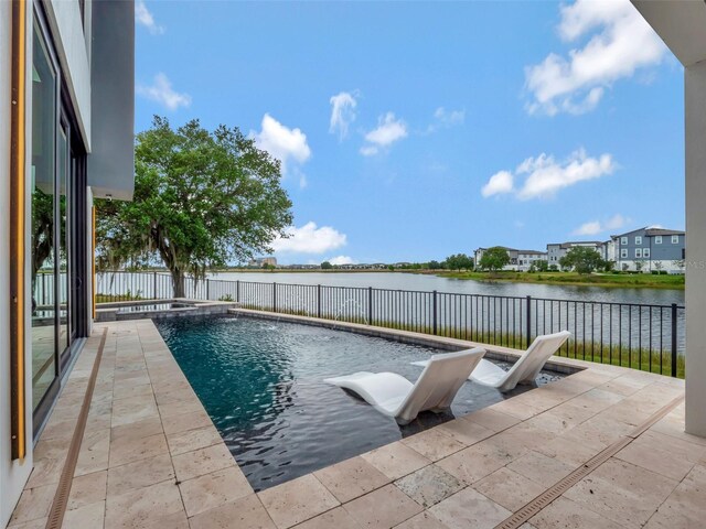 8157 Elion St, Orlando, FL 32827 - view of swimming pool featuring a water view, a fenced backyard, a pool with connected hot tub, and a patio
