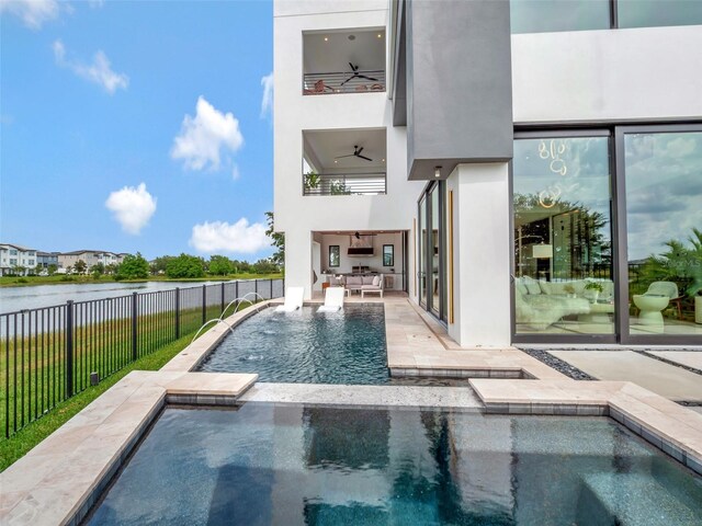 8157 Elion St, Orlando, FL 32827 - view of swimming pool featuring fence, a water view, a patio, and a pool with connected hot tub