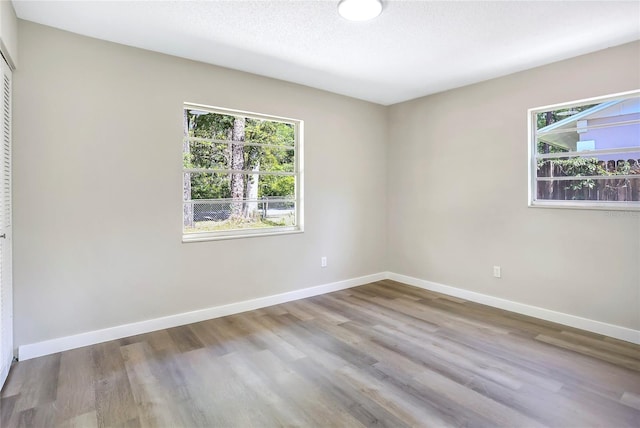 empty room with wood finished floors and baseboards