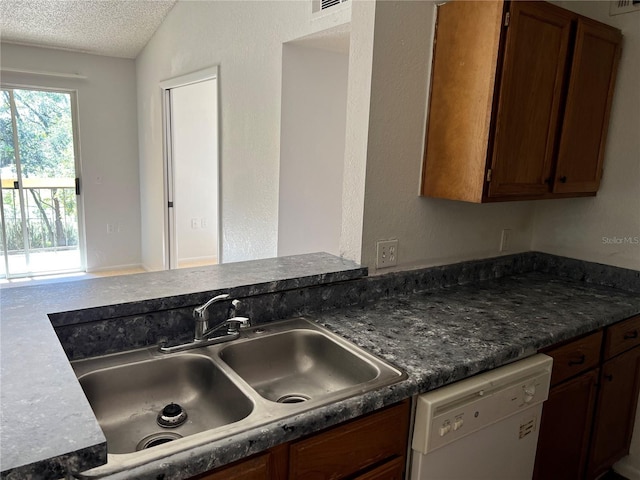 5291 Images Cir Unit 301, Kissimmee, FL 34746 - kitchen featuring dishwasher, a textured ceiling, dark countertops, and brown cabinets