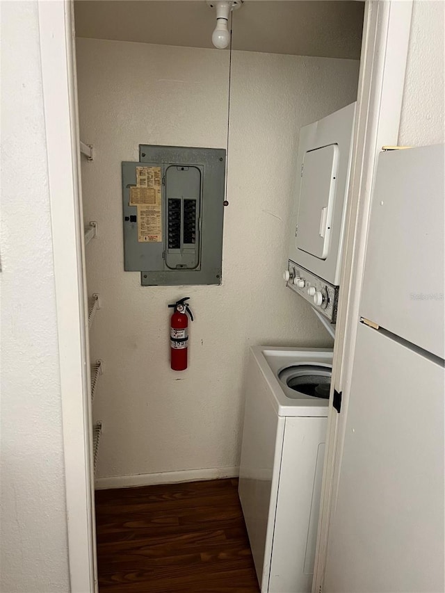 5291 Images Cir Unit 301, Kissimmee, FL 34746 - laundry area with electric panel, stacked washer / dryer, and wood finished floors
