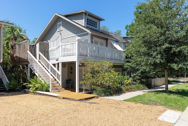 view of front of property with stairs and a deck