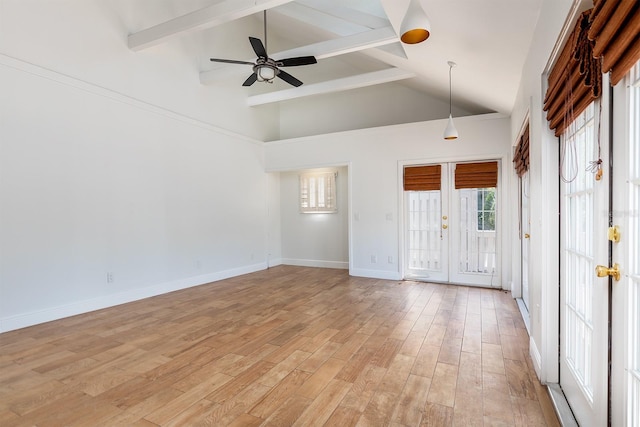 empty room with french doors, beam ceiling, a ceiling fan, baseboards, and light wood-type flooring