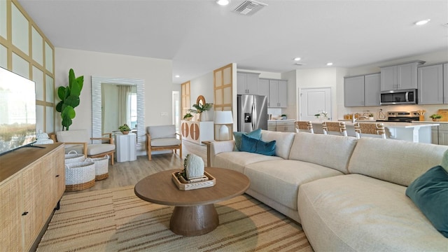 3326 Arch Ave, Ormond Beach, FL 32174 - living room with light wood-style flooring and recessed lighting