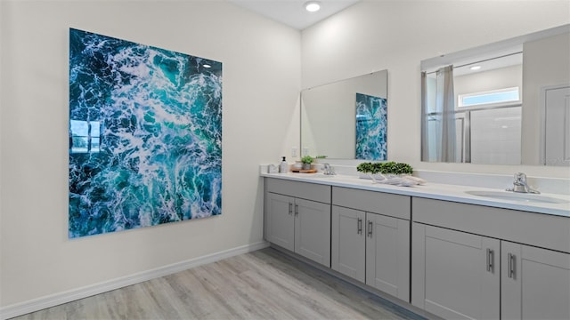 3326 Arch Ave, Ormond Beach, FL 32174 - bathroom featuring wood finished floors, double vanity, recessed lighting, and baseboards