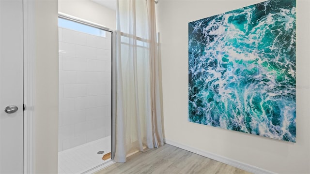 3326 Arch Ave, Ormond Beach, FL 32174 - bathroom featuring a shower stall, wood finished floors, and baseboards