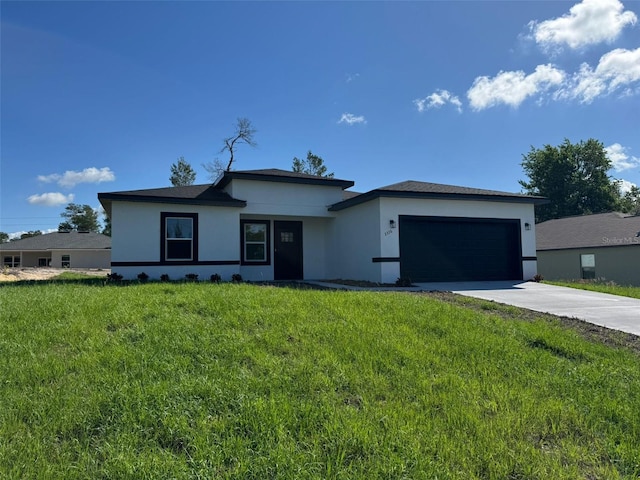 2336 SW 168th Loop, Ocala, FL 34473 - prairie-style house with stucco siding, a garage, concrete driveway, and a front lawn