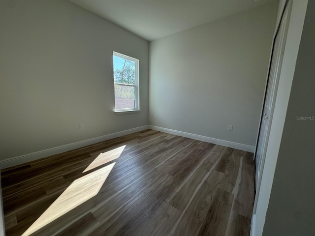 2336 SW 168th Loop, Ocala, FL 34473 - unfurnished room featuring baseboards and dark wood-style flooring