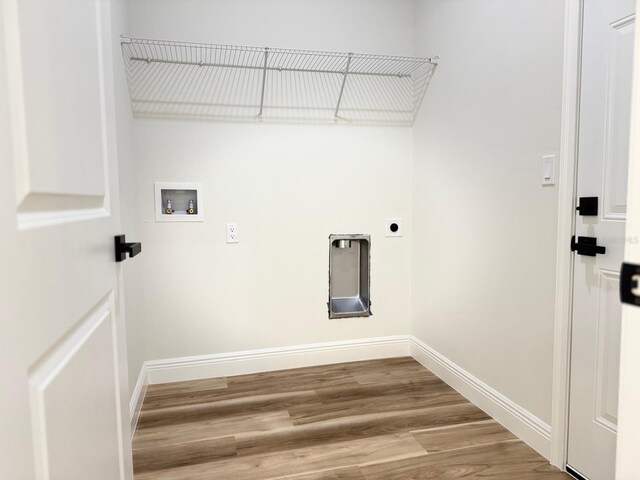 2336 SW 168th Loop, Ocala, FL 34473 - laundry room featuring electric dryer hookup, hookup for a washing machine, baseboards, and wood finished floors