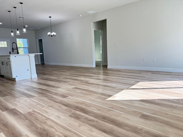 2336 SW 168th Loop, Ocala, FL 34473 - unfurnished living room featuring a chandelier, baseboards, light wood-style floors, and recessed lighting