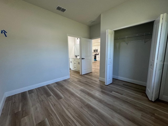 2336 SW 168th Loop, Ocala, FL 34473 - unfurnished bedroom with dark wood-type flooring, baseboards, and a closet